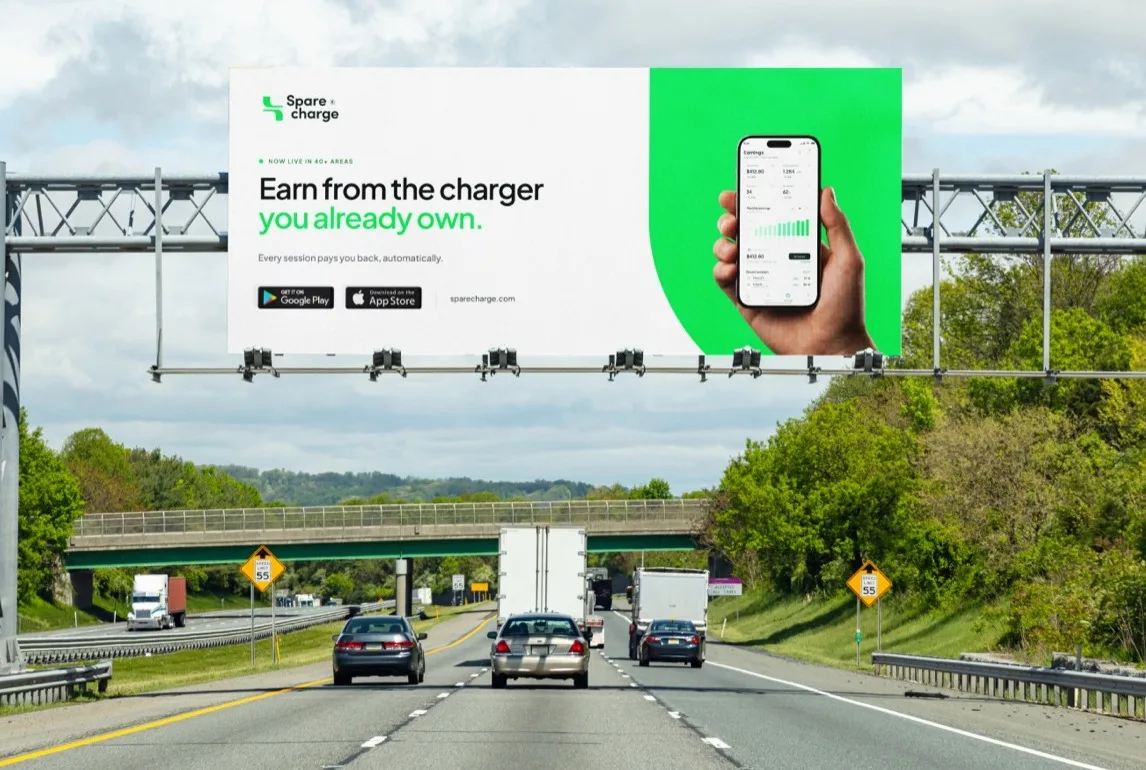 SpareCharge logo over a highway billboard for the SpareCharge app