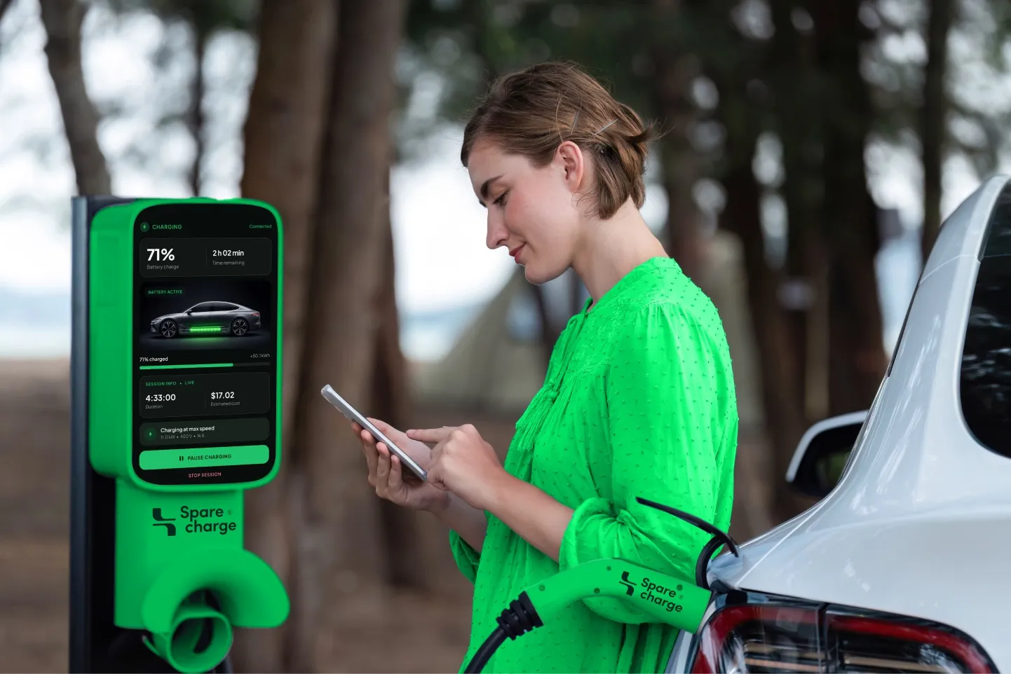 Woman using the SpareCharge app on her phone next to a charger