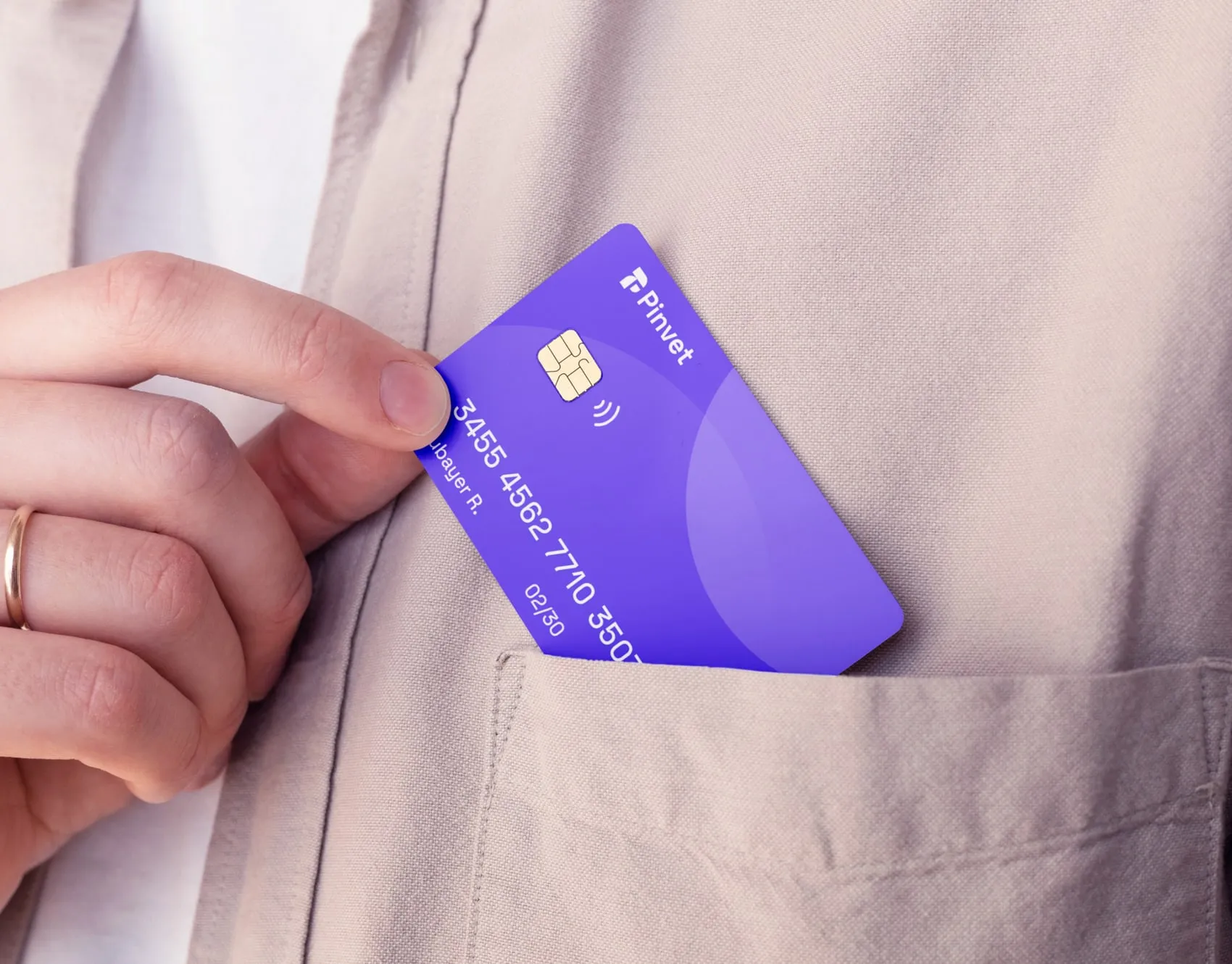 Hand sliding a purple Pinvet card into a shirt pocket