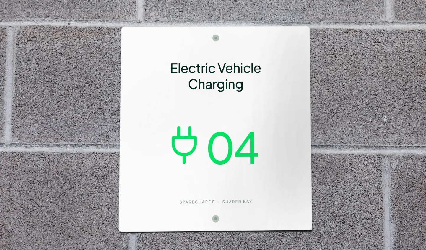 Electric vehicle charging bay sign number 04 on a brick wall