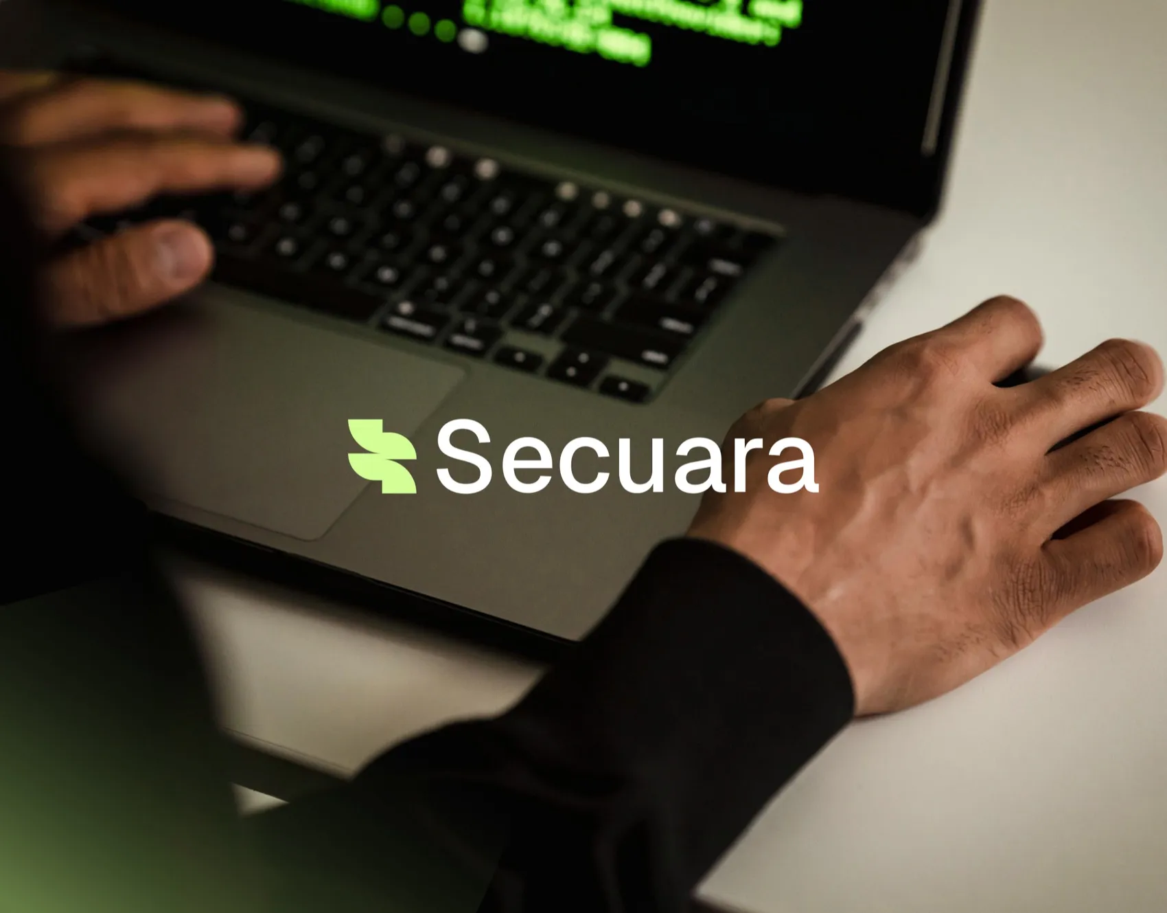 Secuara logo over hands typing on a laptop keyboard