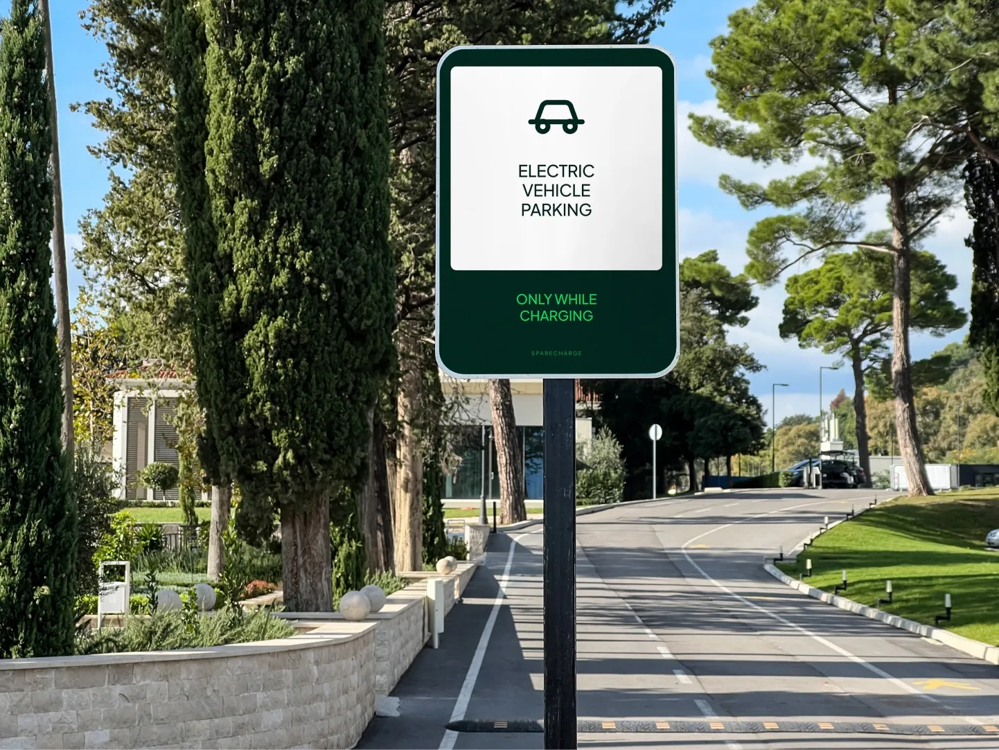 Electric vehicle parking sign on a tree-lined street