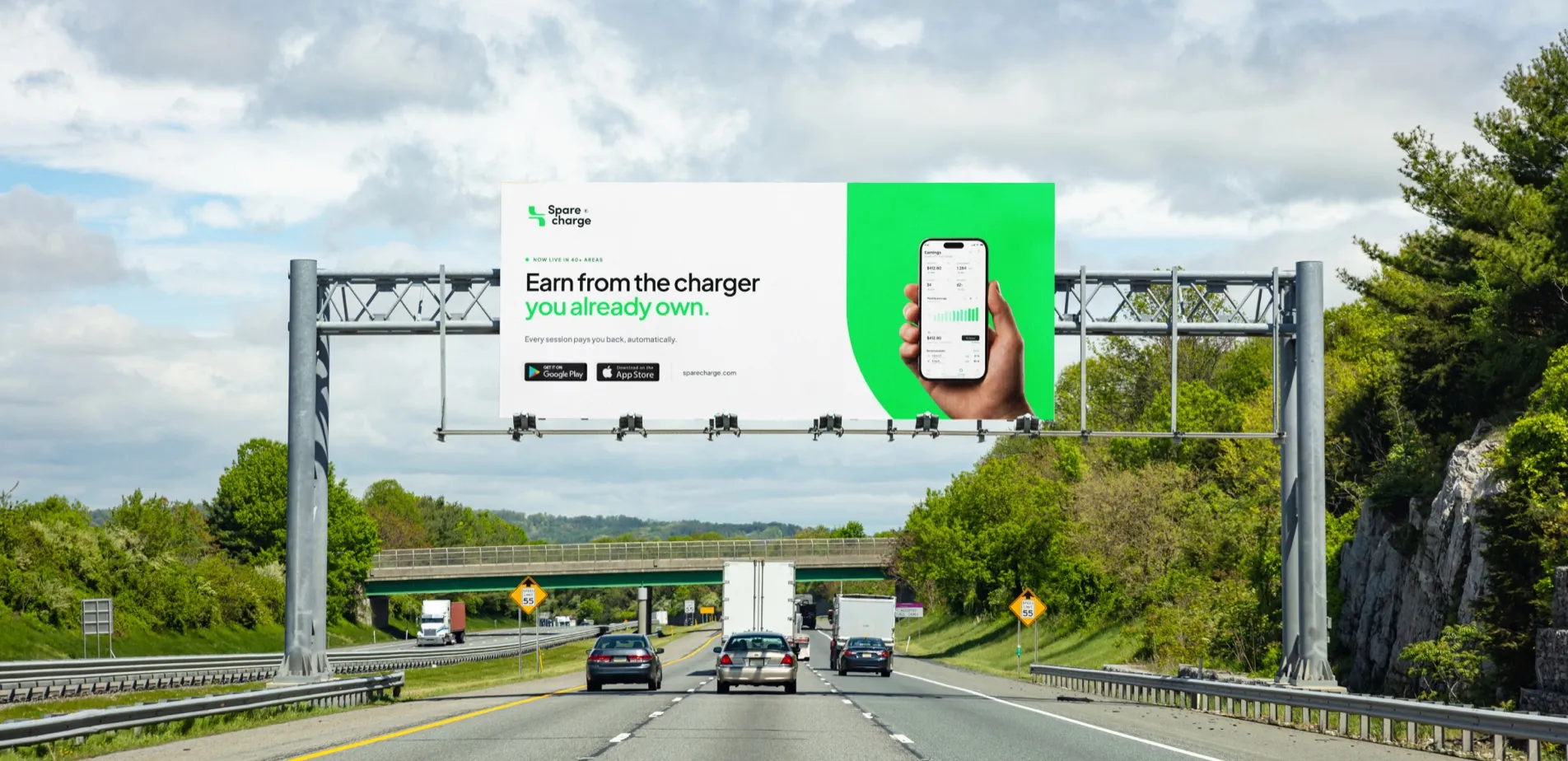SpareCharge logo over a highway billboard for the SpareCharge app