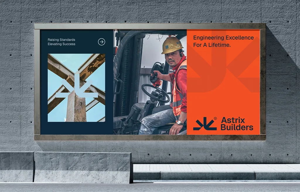Astrix Builders billboard on a concrete wall: a site worker beside the orange “Engineering Excellence For A Lifetime” panel
