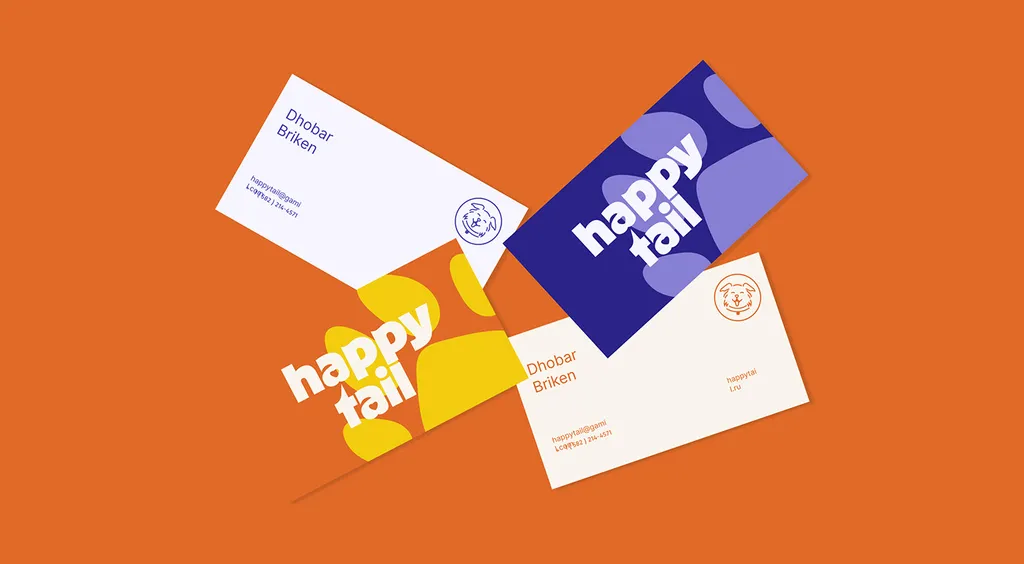 Happy Tail business cards in orange, yellow, indigo and cream, scattered on an orange background