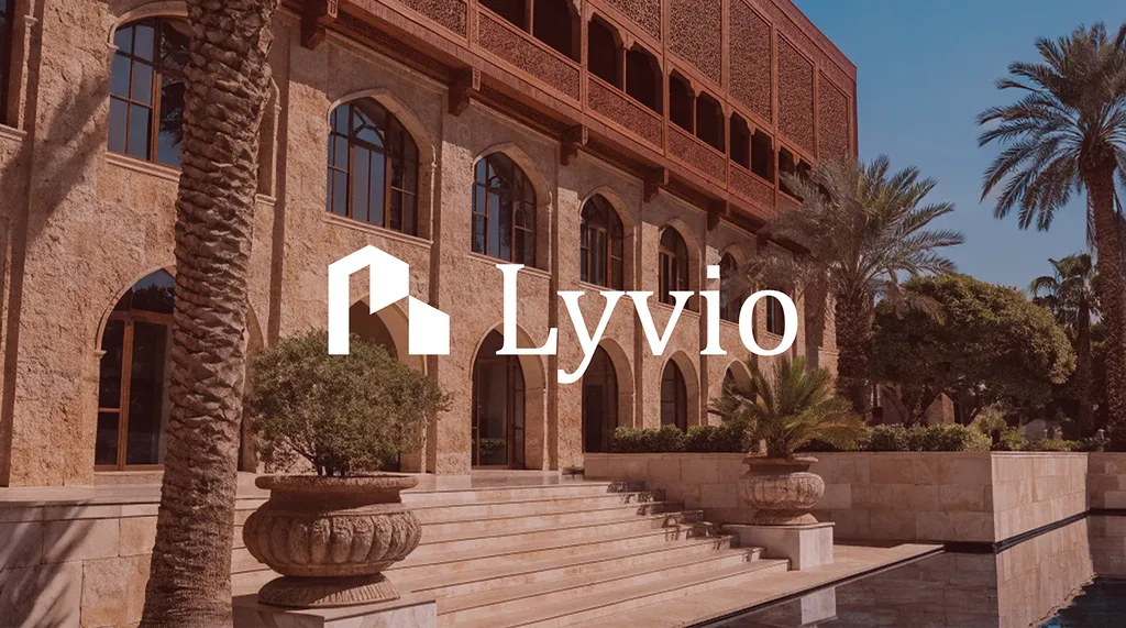 Lyvio logo in white over a sunlit courtyard of a traditional Arabian building