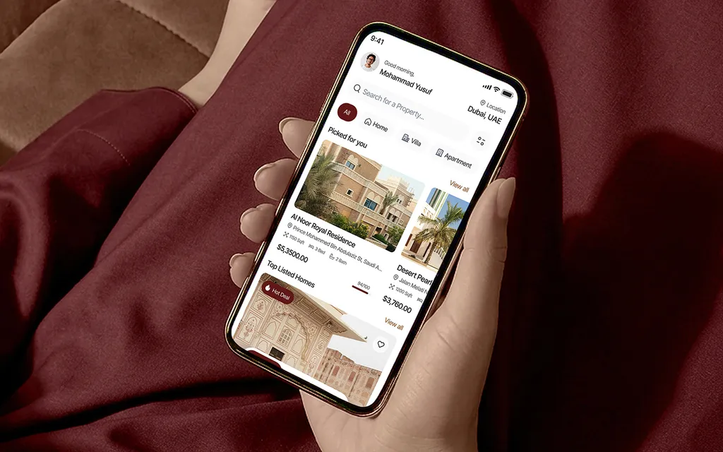 Hand holding a phone with the Lyvio app on burgundy fabric