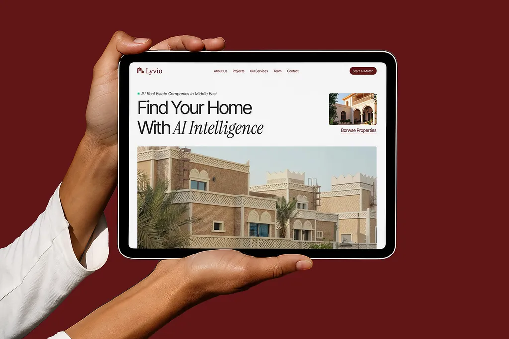 Hands holding a tablet with the Lyvio website on burgundy