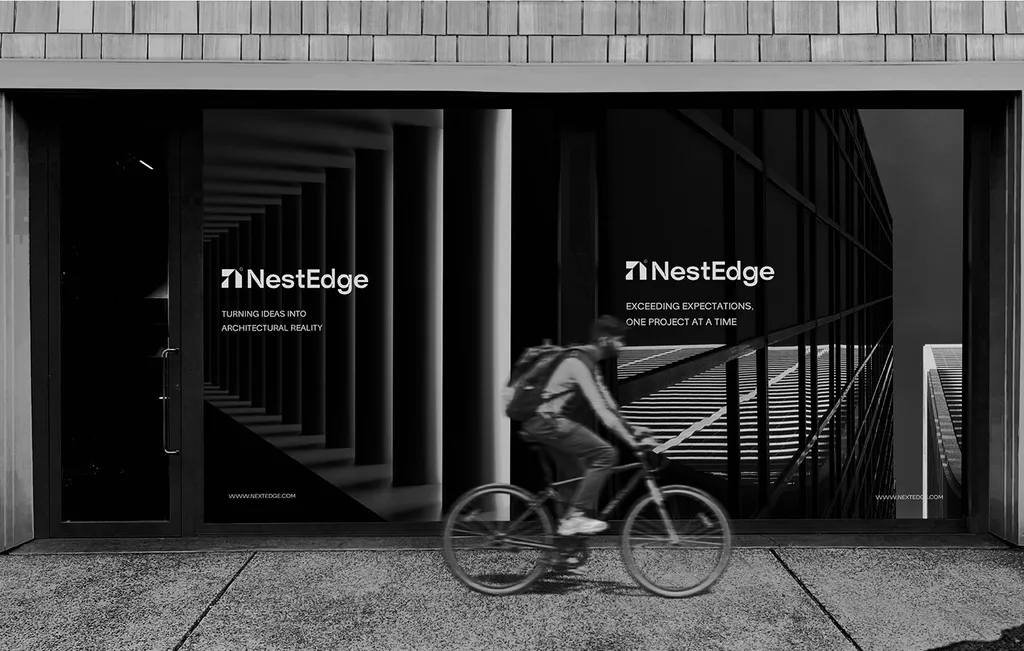NestEdge shopfront windows with “Turning ideas into architectural reality” and a cyclist riding past