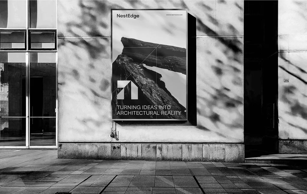 NestEdge poster on a sunlit wall: the white mark over dark rock and “Turning ideas into architectural reality”