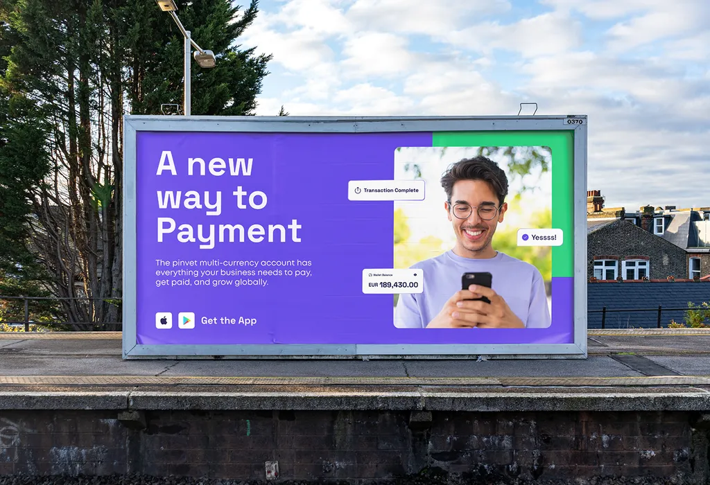 Pinvet billboard on a train platform: “A new way to Payment” next to a smiling man looking at his phone