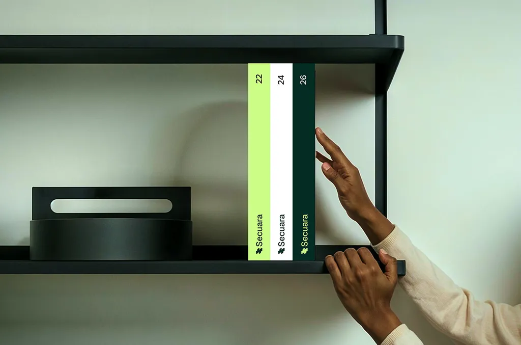 Hand placing a Secuara binder on a shelf