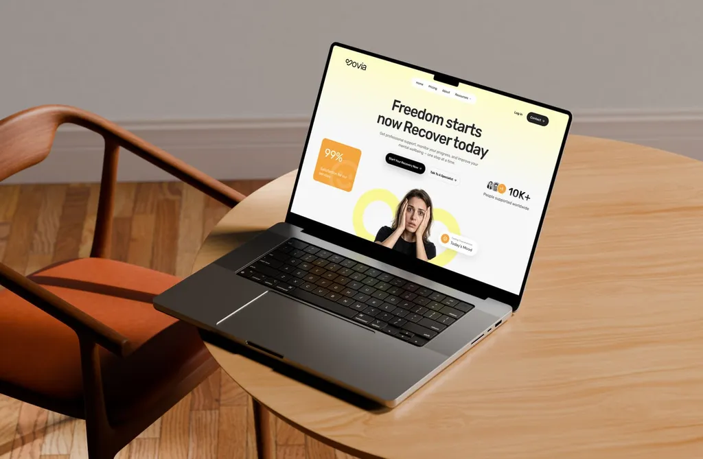 Laptop on a wooden table showing the Sovia homepage
