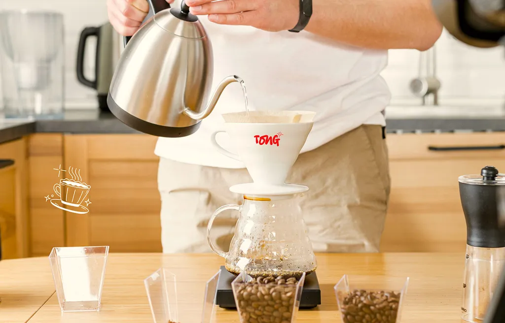 Barista pouring a pour-over coffee into a Tong dripper
