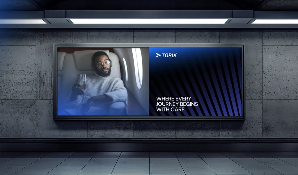 TORIX billboard in a concrete underpass: a traveler with a drink in a plane seat and “Where Every Journey Begins With Care”