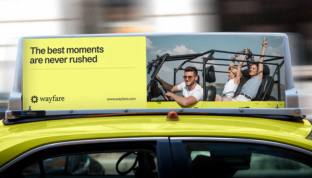 Wayfare roof sign on a lime car reading “The best moments are never rushed”