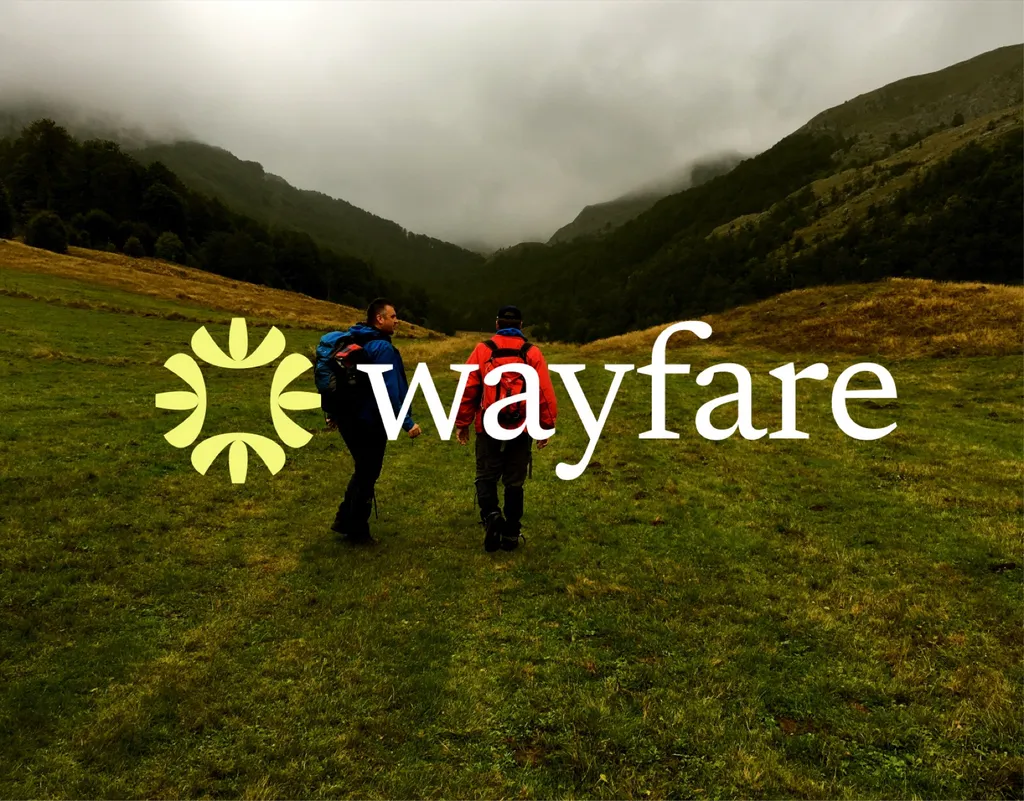 Wayfare logo with a sun symbol over two hikers in a green valley